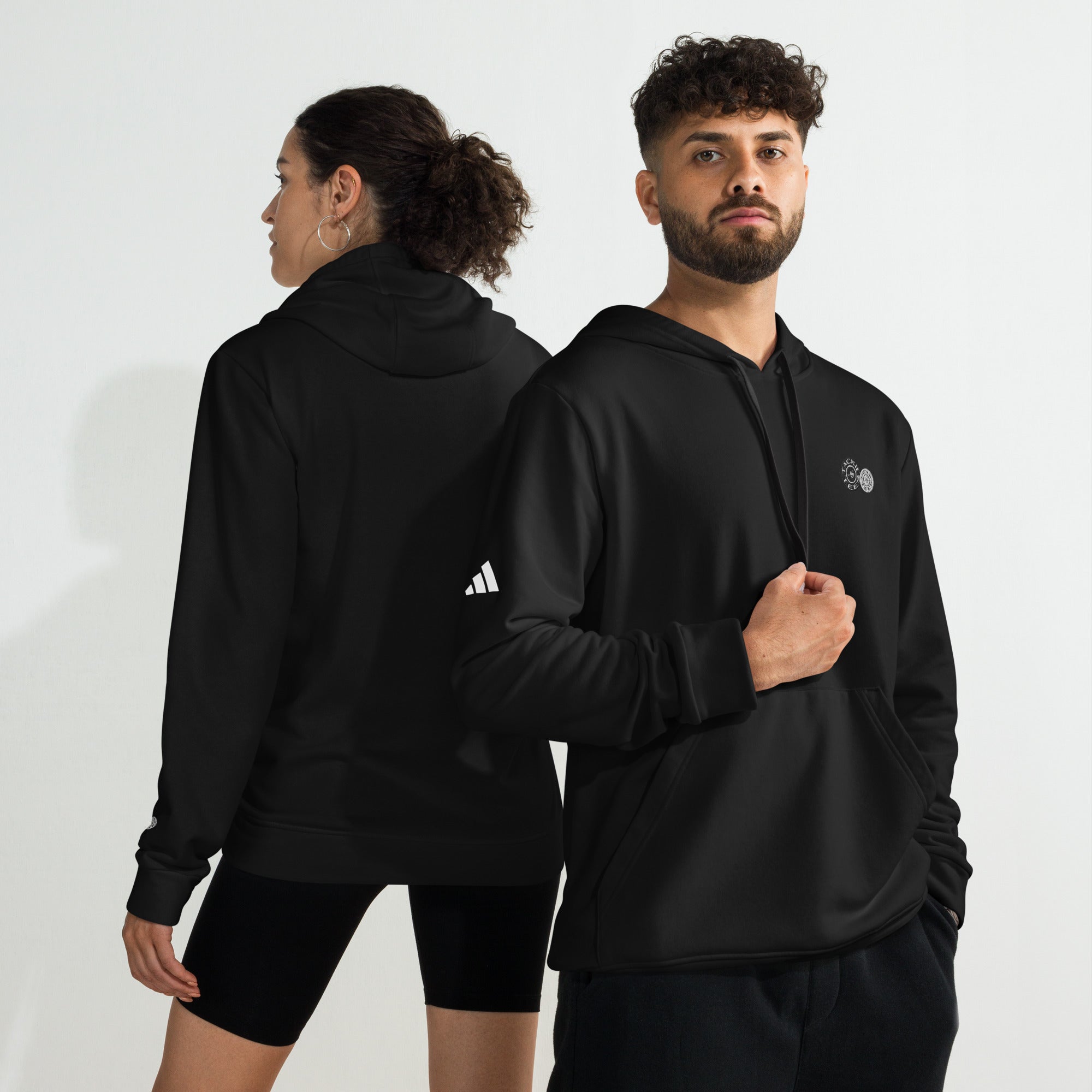 Two models wearing Adidas x Signature embroidered fleece hoodies in black, showcasing front and back views of the comfy hoodie sweatshirt.